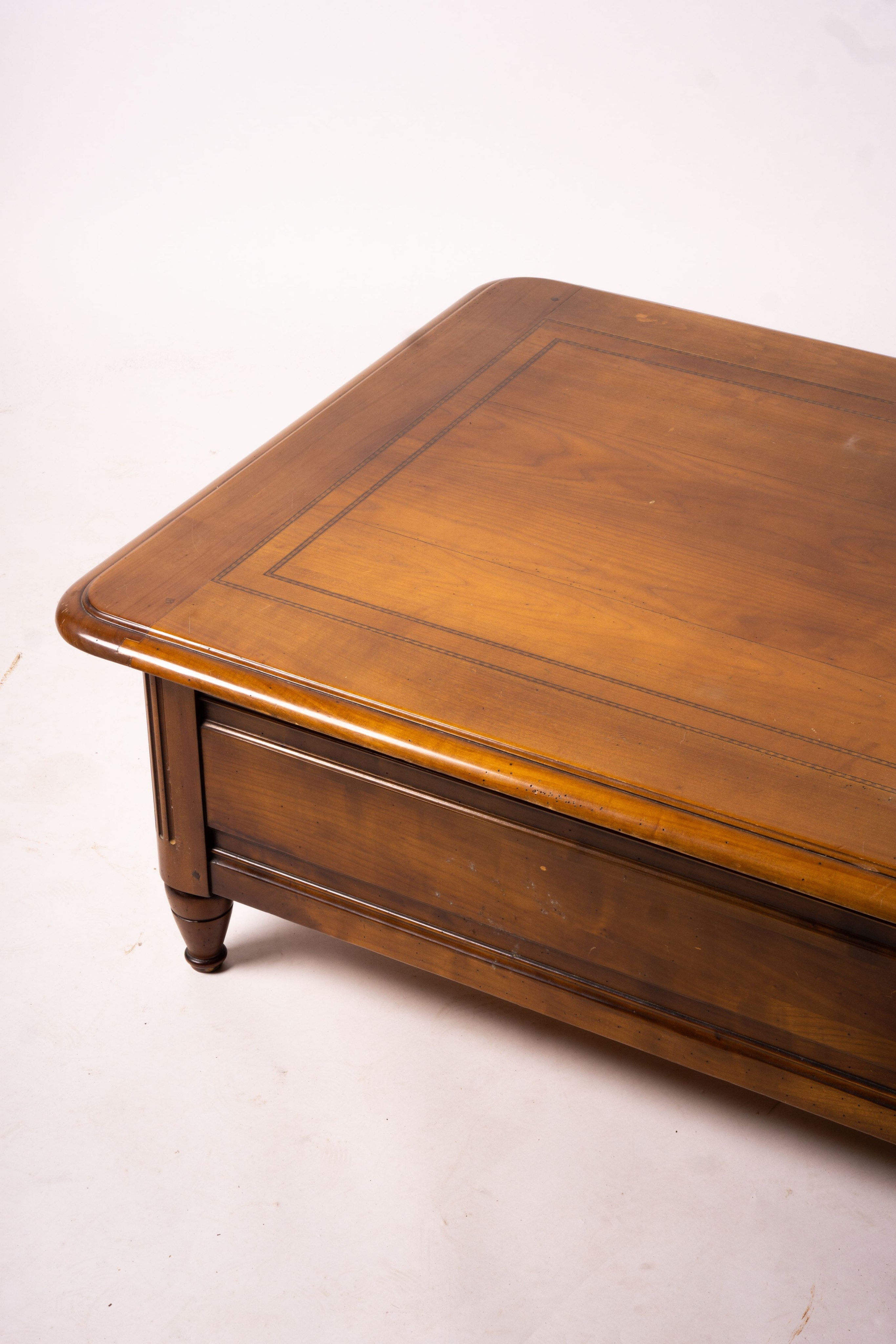 A reproduction rectangular walnut coffee table with rising top enclosing a wine bottle storage interior, length 130cm, depth 85cm, height 41cm